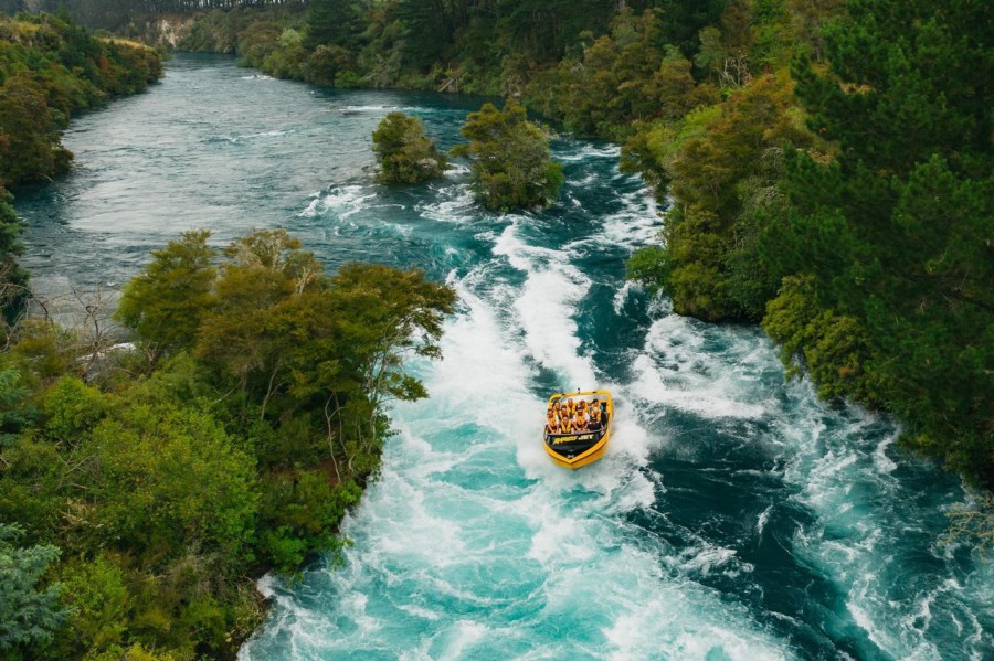 A jet boat riding through white water rapids